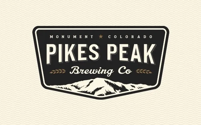 The Pikes Peak Brewing Co. badge: a dark shield with the mountain at its base, Monument, Colorado above the name