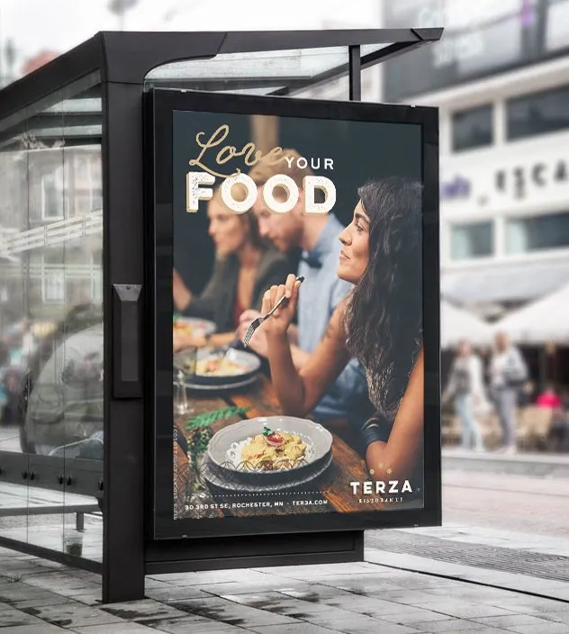 A Terza “Love your food” poster in a city bus shelter