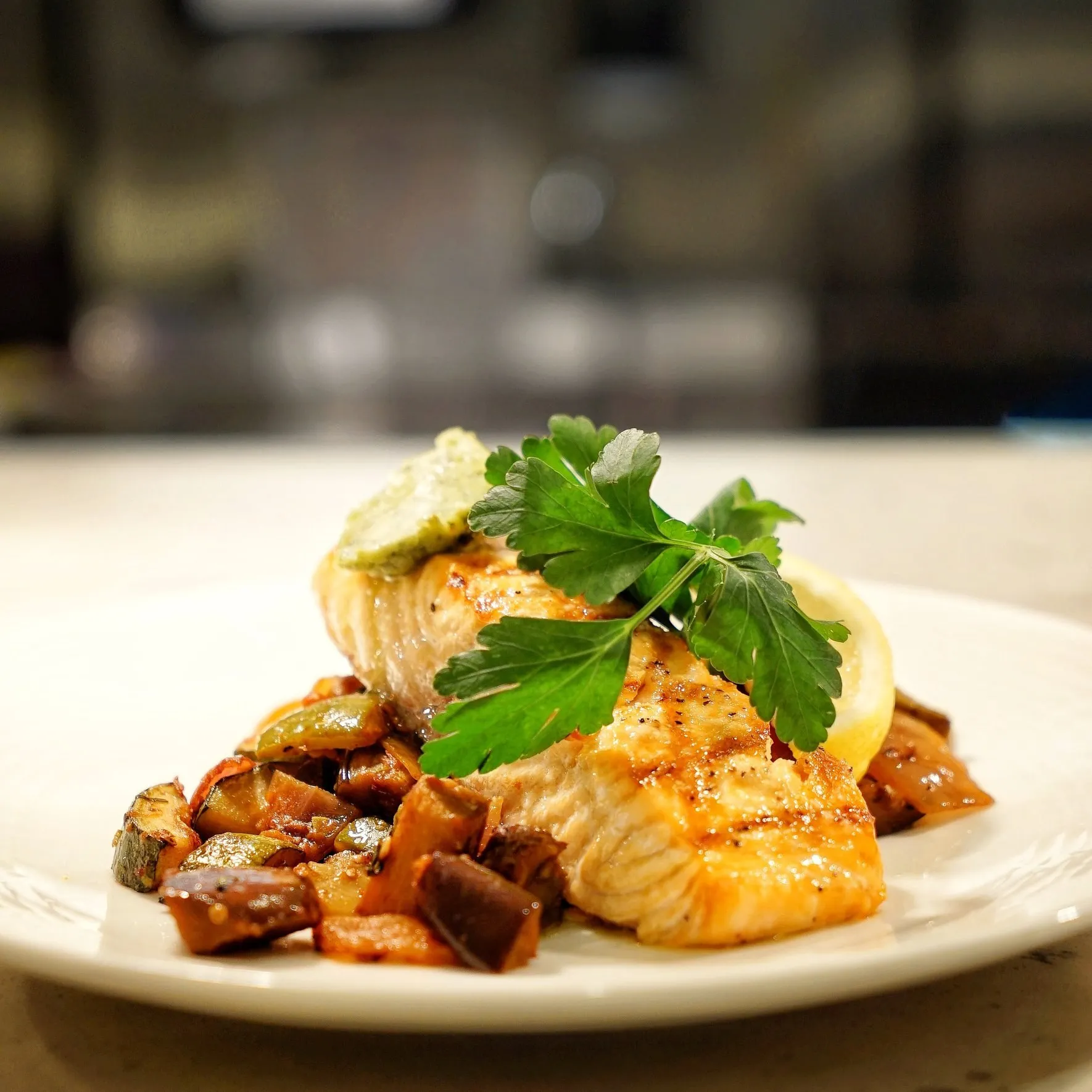 A plated fish dish with herbs and sauce from the La Vetta kitchen