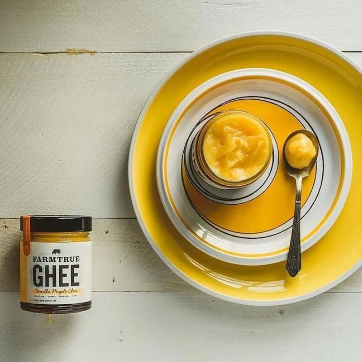 A pretzel, coffee and a dish of ghee on a wooden board, from above