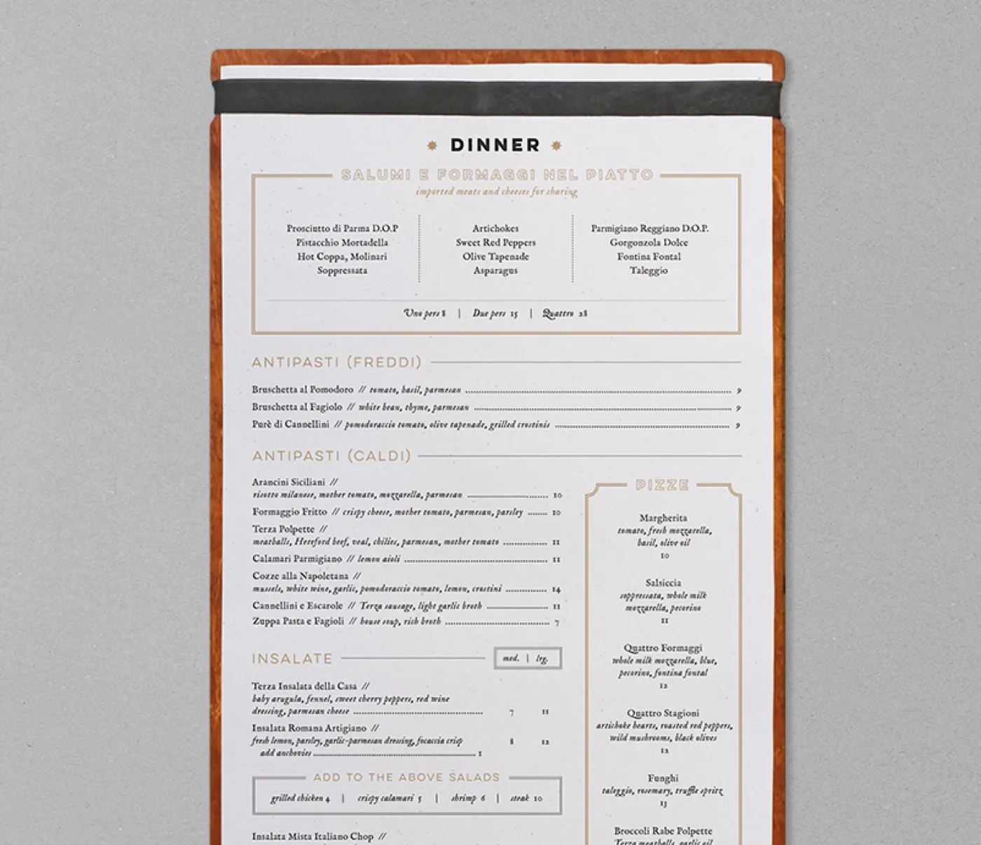 The Terza Ristorante dinner menu on a leather-bound board, set in gold and black
