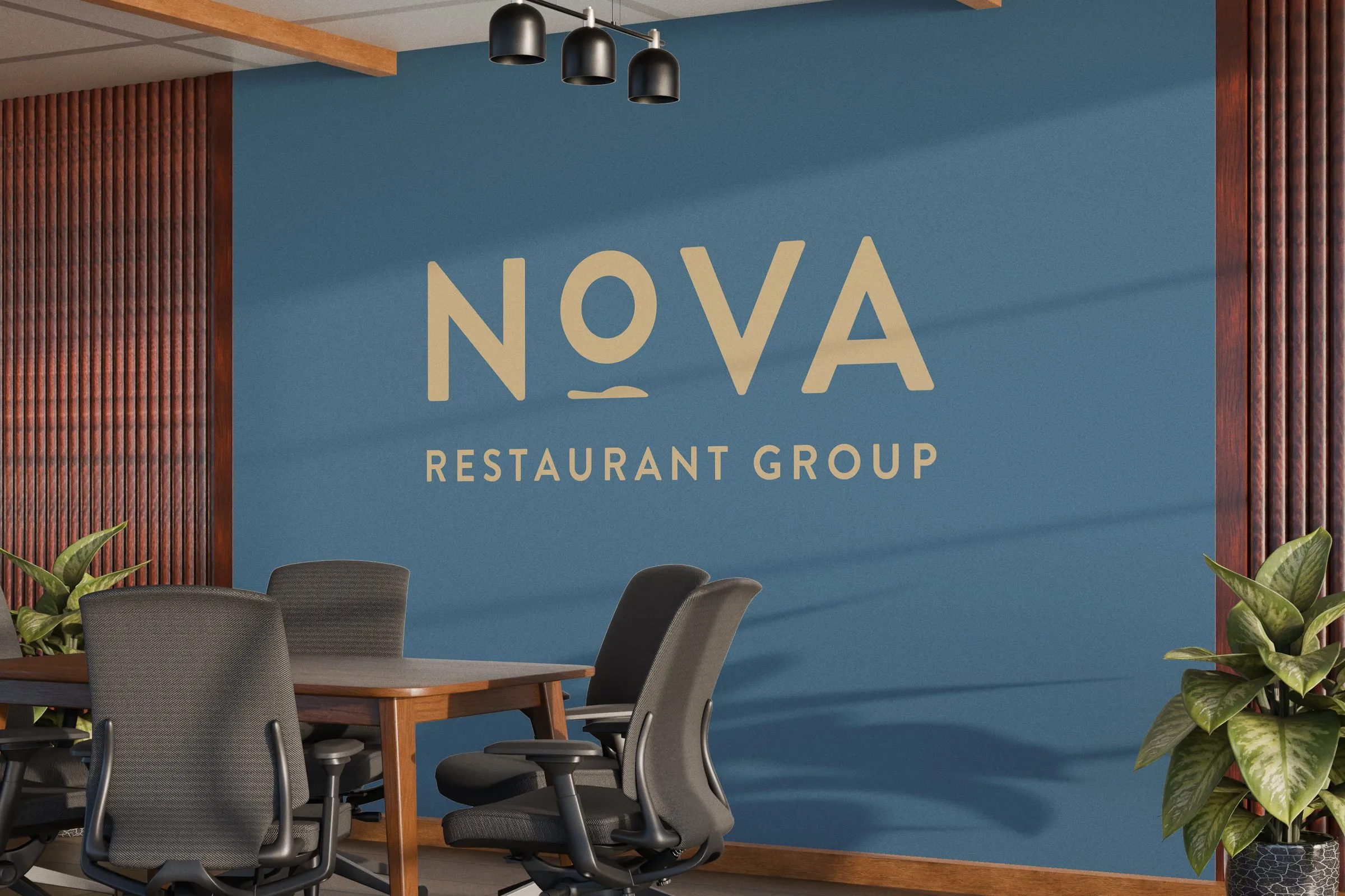The Nova Restaurant Group wordmark in gold on a blue wall of the group’s office, above a meeting table and chairs