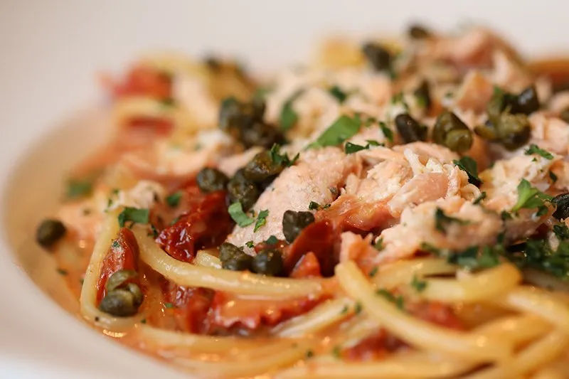 A bowl of Terza pasta with salmon, capers and herbs