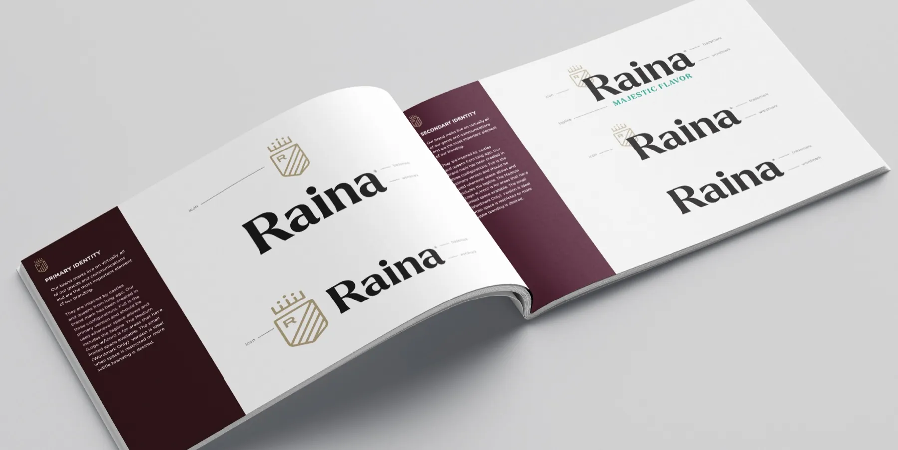 The Raina identity standards, open to a spread of the wordmark and crowned R shield in plum, cream and gold