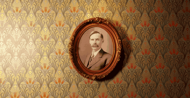 Light travelling across the custom gold wallpaper and the framed portrait of Andrew Volstead